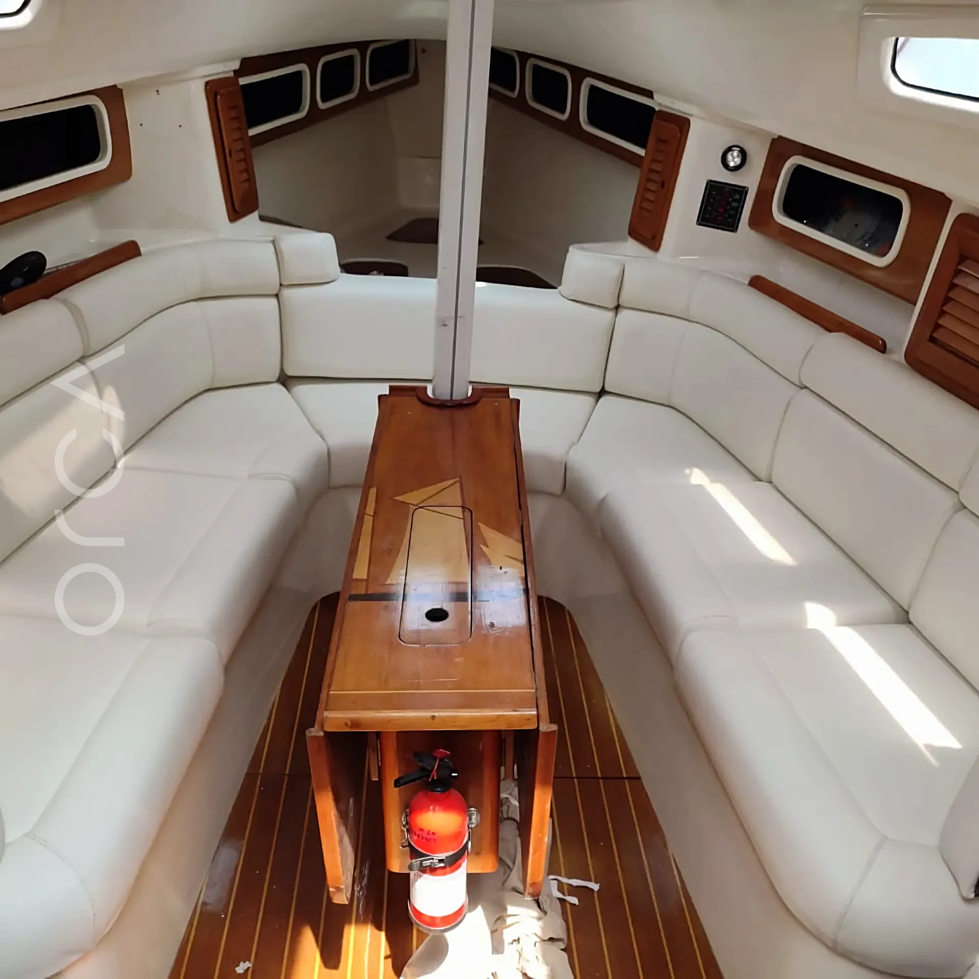 A Malbec 290 sailing yacht in Mumbai, the saloon below deck, available to rent from Orca Sail.