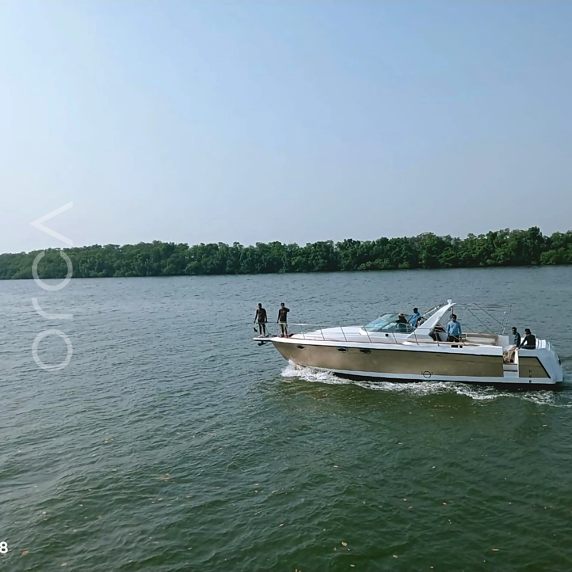 A Formula 40 motor yacht in Goa, seen from the water, available to rent from Orca Sail.