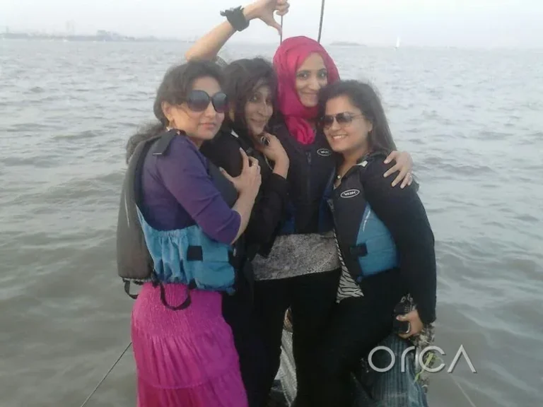 A group of friends on deck during a sail in Mumbai