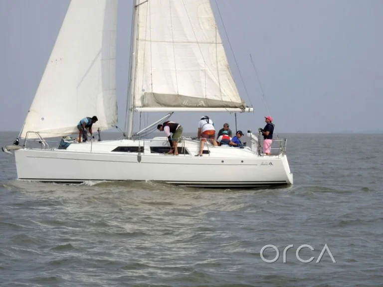 A sail yacht under full sail with guests aboard off Mumbai