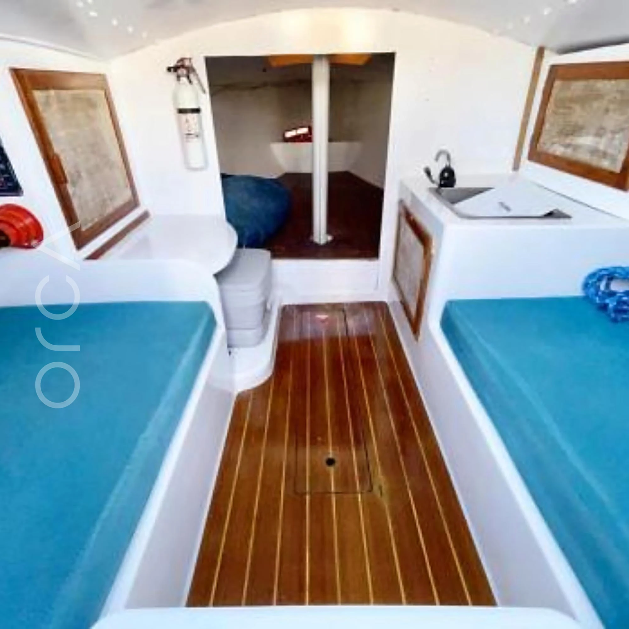 The cabin of a J24 sailboat, the same class as this boat, shown for its layout. Available to rent in Mumbai from Orca Sail.