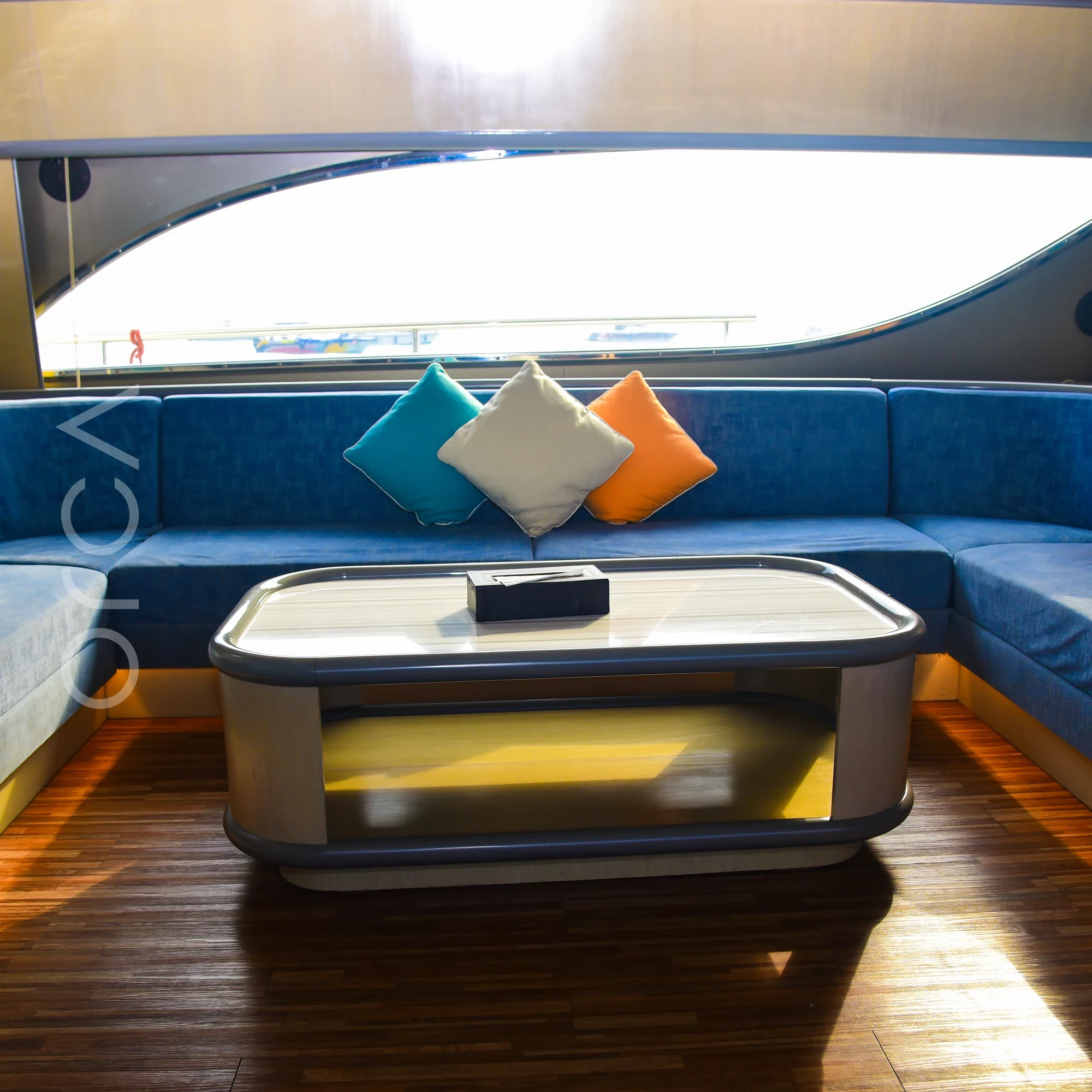 The main seating area aboard a Ferretti 88 luxury motor yacht in Mumbai, available to rent from Orca Sail.