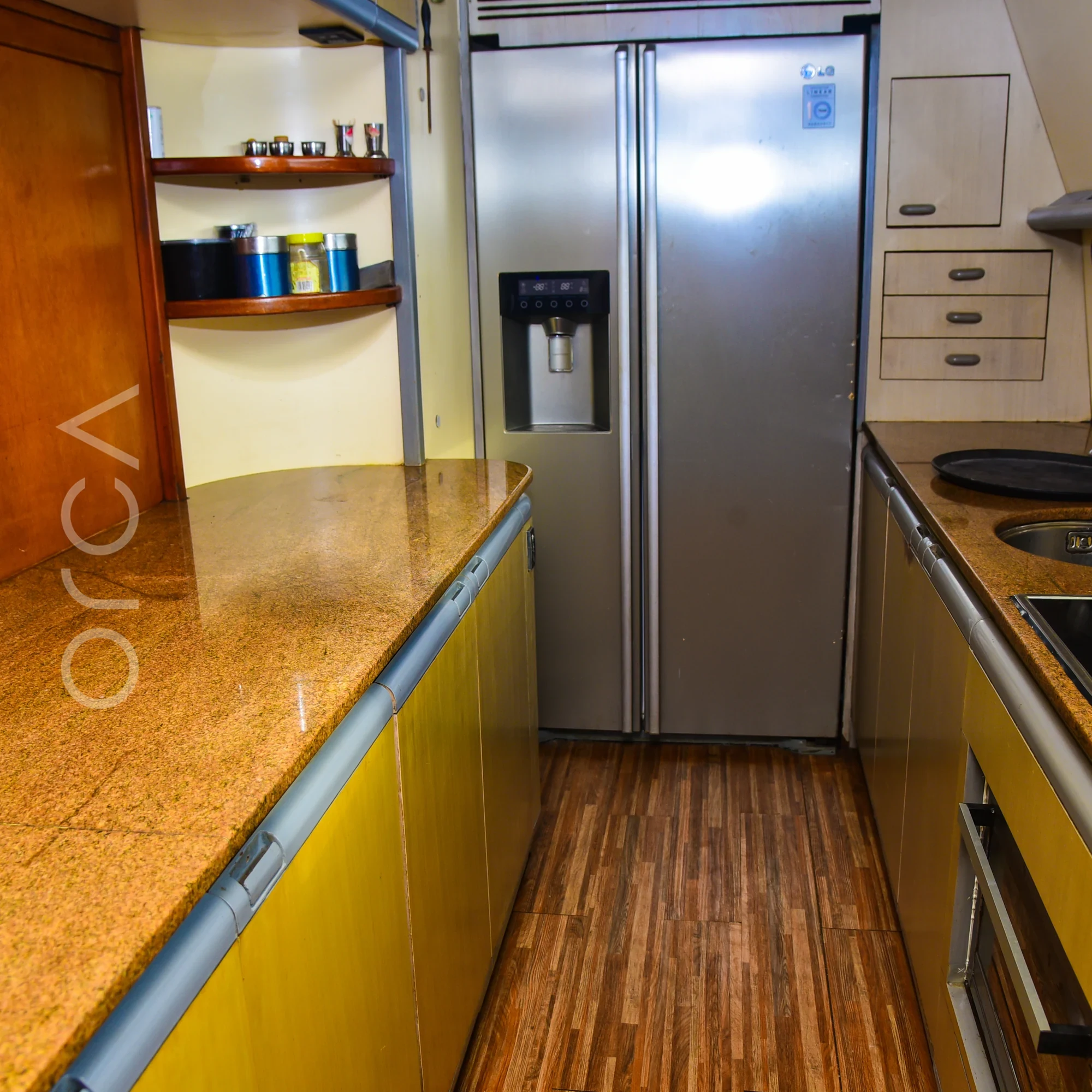 The galley aboard a Ferretti 88 luxury motor yacht in Mumbai, available to rent from Orca Sail.