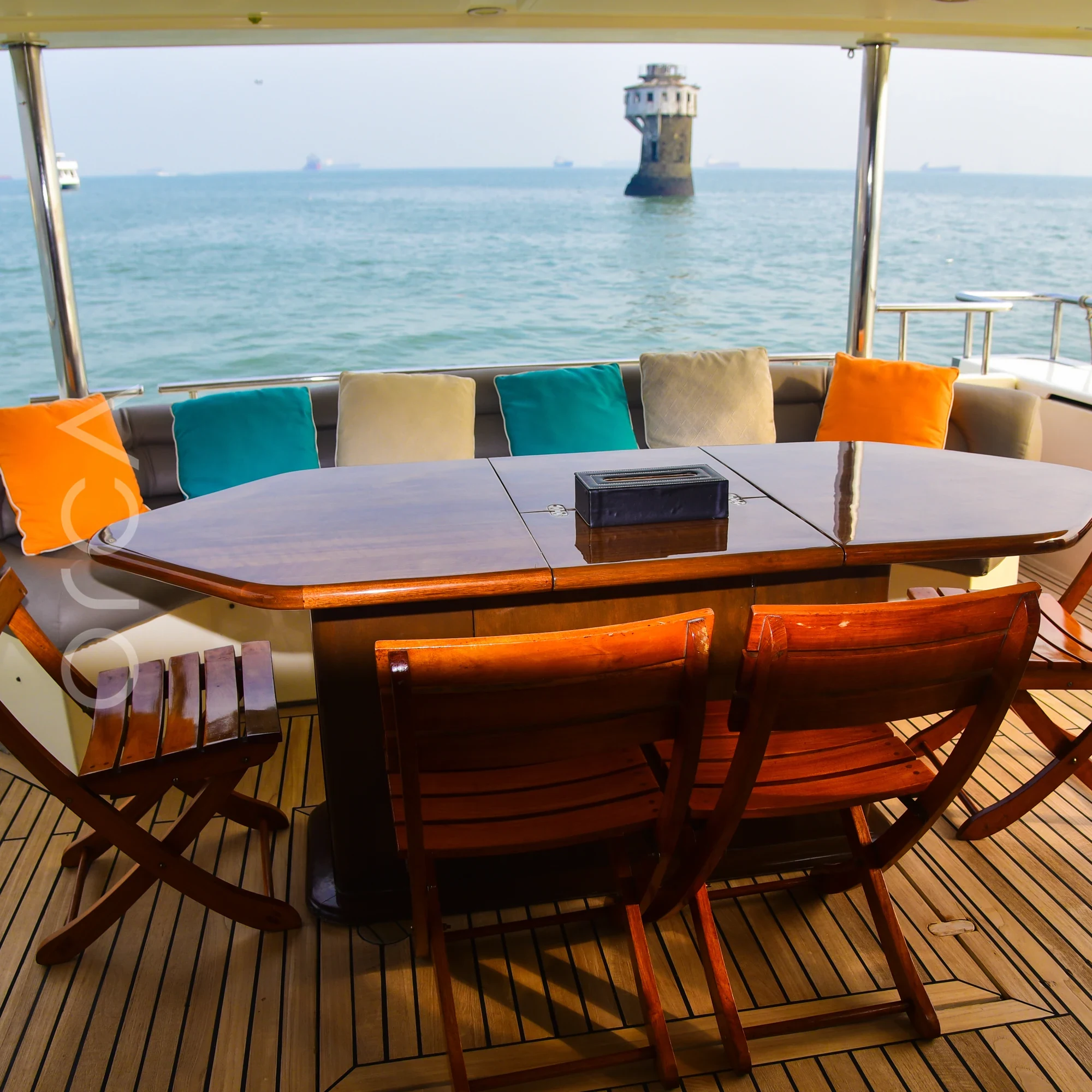 The aft deck of a Ferretti 88 luxury motor yacht in Mumbai, available to rent from Orca Sail.