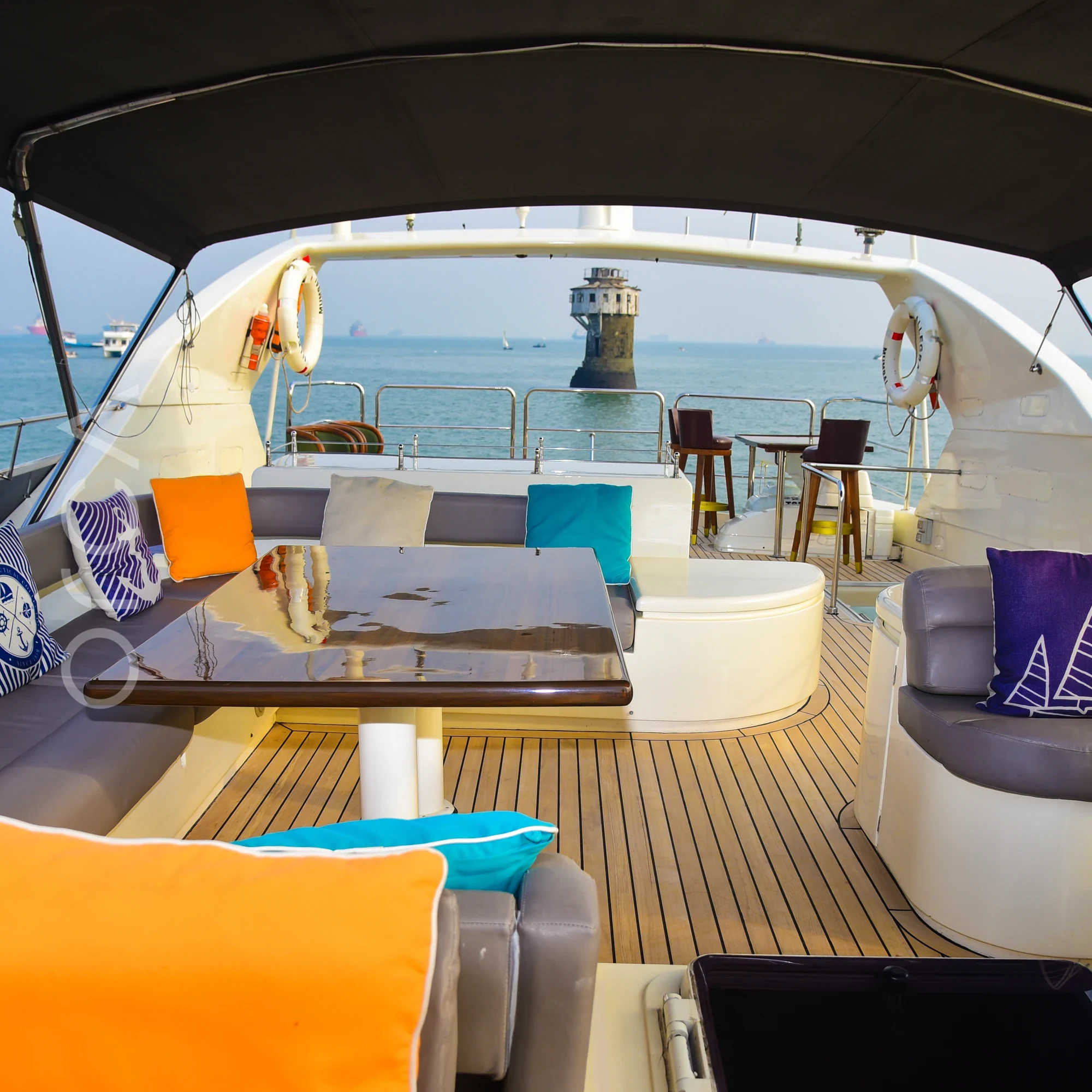 The upper deck and helm area of a Ferretti 88 luxury motor yacht in Mumbai, available to rent from Orca Sail.