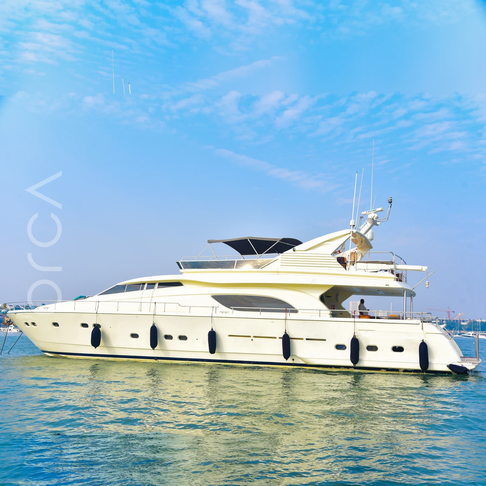 A Ferretti 88 luxury motor yacht seen side-on in Mumbai, available to rent from Orca Sail.