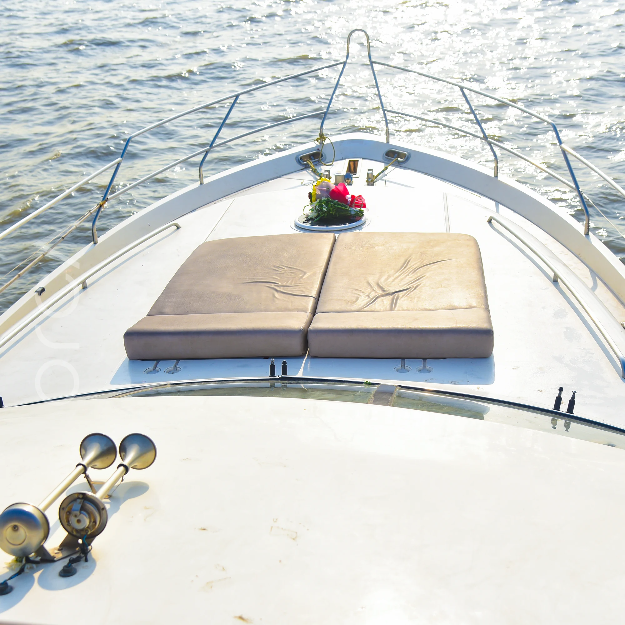 The sunpad on the bow deck of a Princess 61 motor yacht in Mumbai, available to rent from Orca Sail.