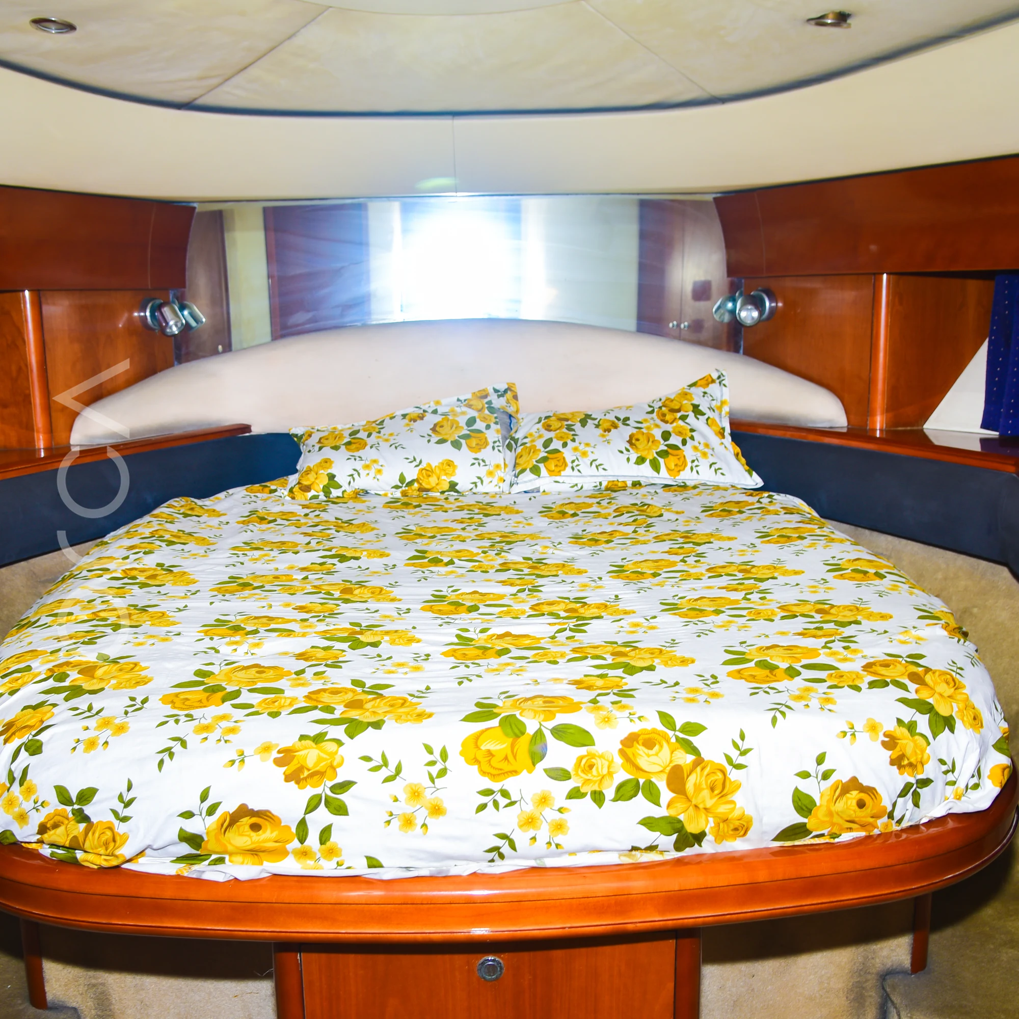 The master cabin of a Princess 61 motor yacht in Mumbai, with an island double bed, available to rent from Orca Sail.