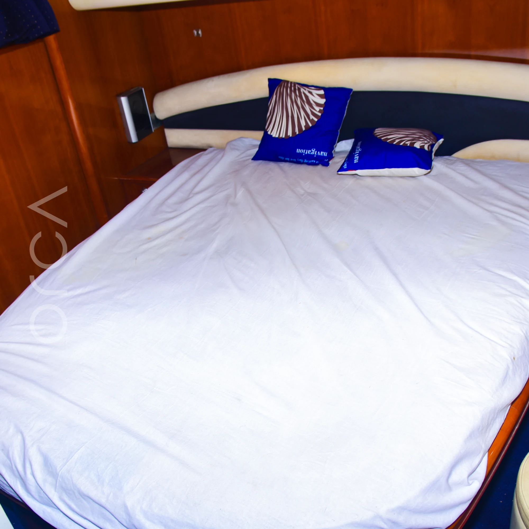 A second cabin aboard a Princess 61 motor yacht in Mumbai, with a double bed, available to rent from Orca Sail.