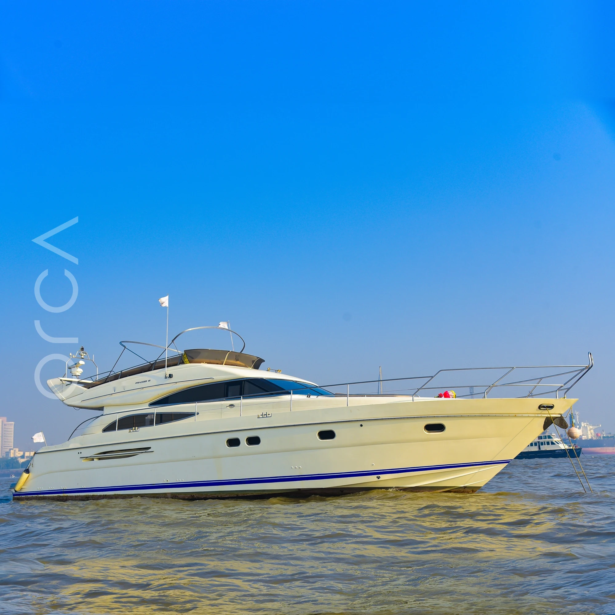 The full length of a Princess 61 motor yacht seen side-on in Mumbai harbour, available to rent from Orca Sail.