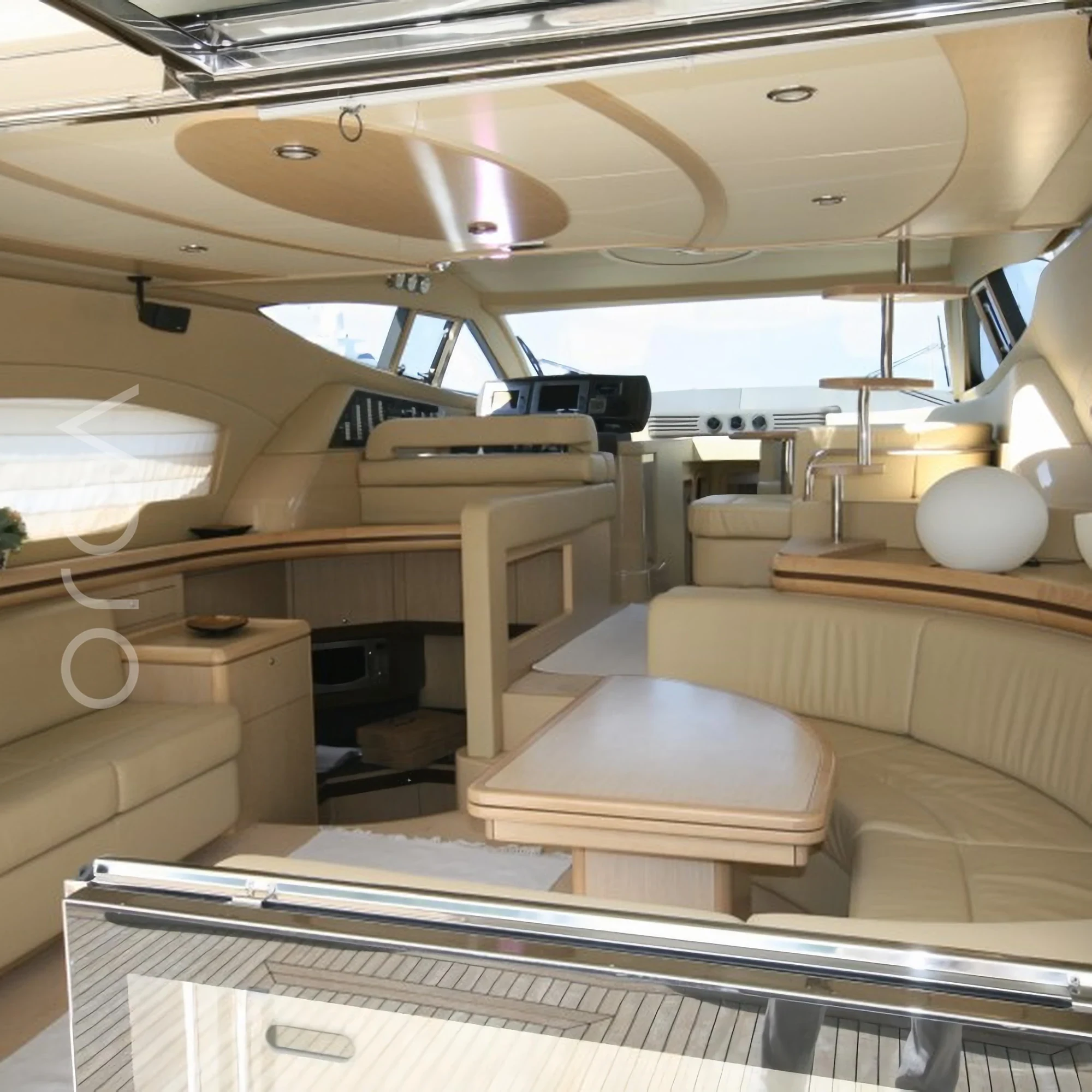 The main seating area aboard a Ferretti 550 luxury motor yacht in Goa, representing the boats available to rent from Orca Sail.