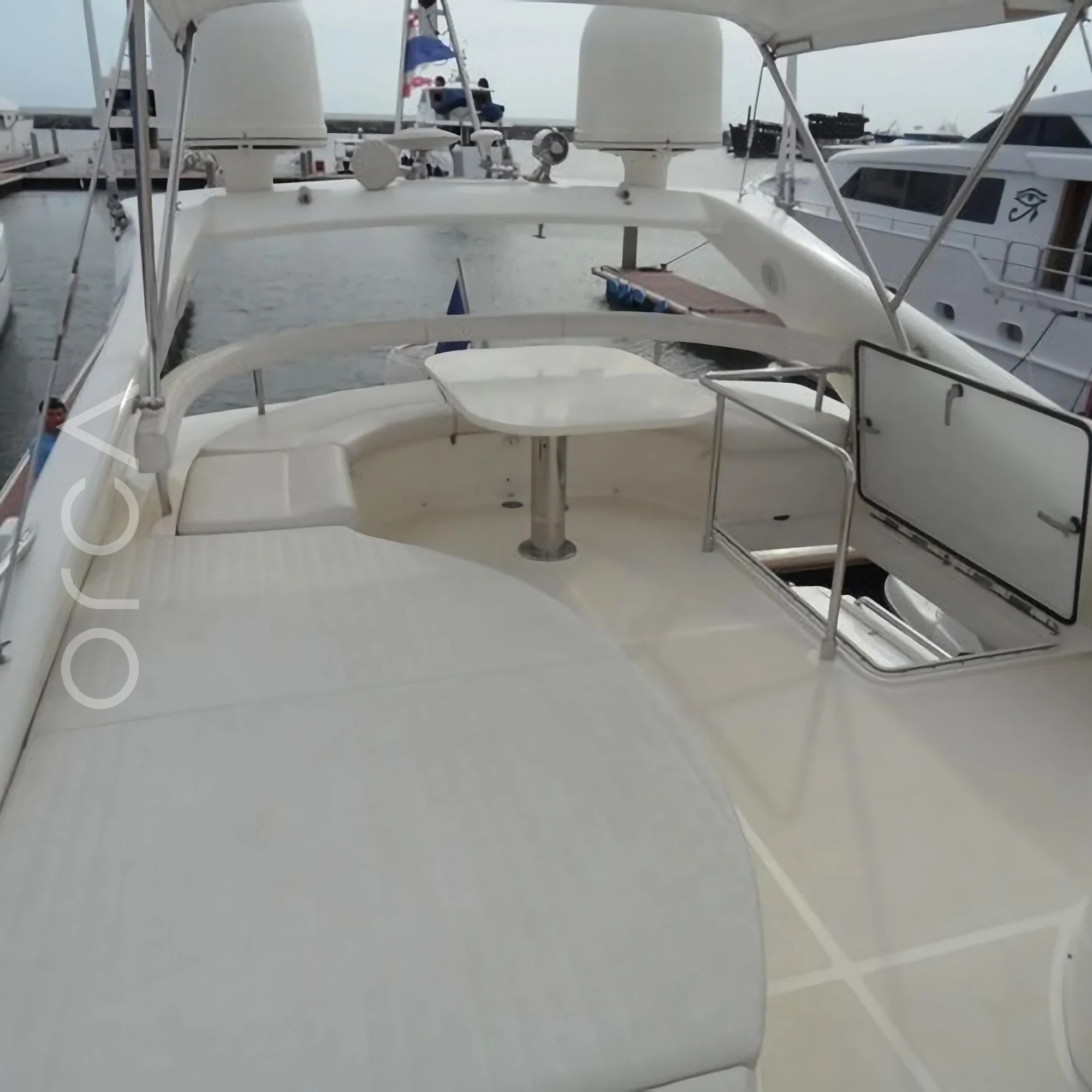 The upper deck and helm area of a Ferretti 550 luxury motor yacht in Goa, representing the boats available to rent from Orca Sail.