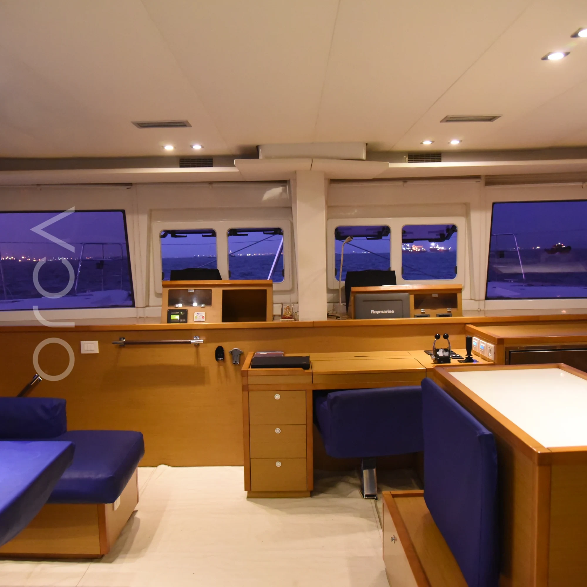 The main seating area aboard a Lagoon 560 luxury sail yacht catamaran in Mumbai, available to rent from Orca Sail.