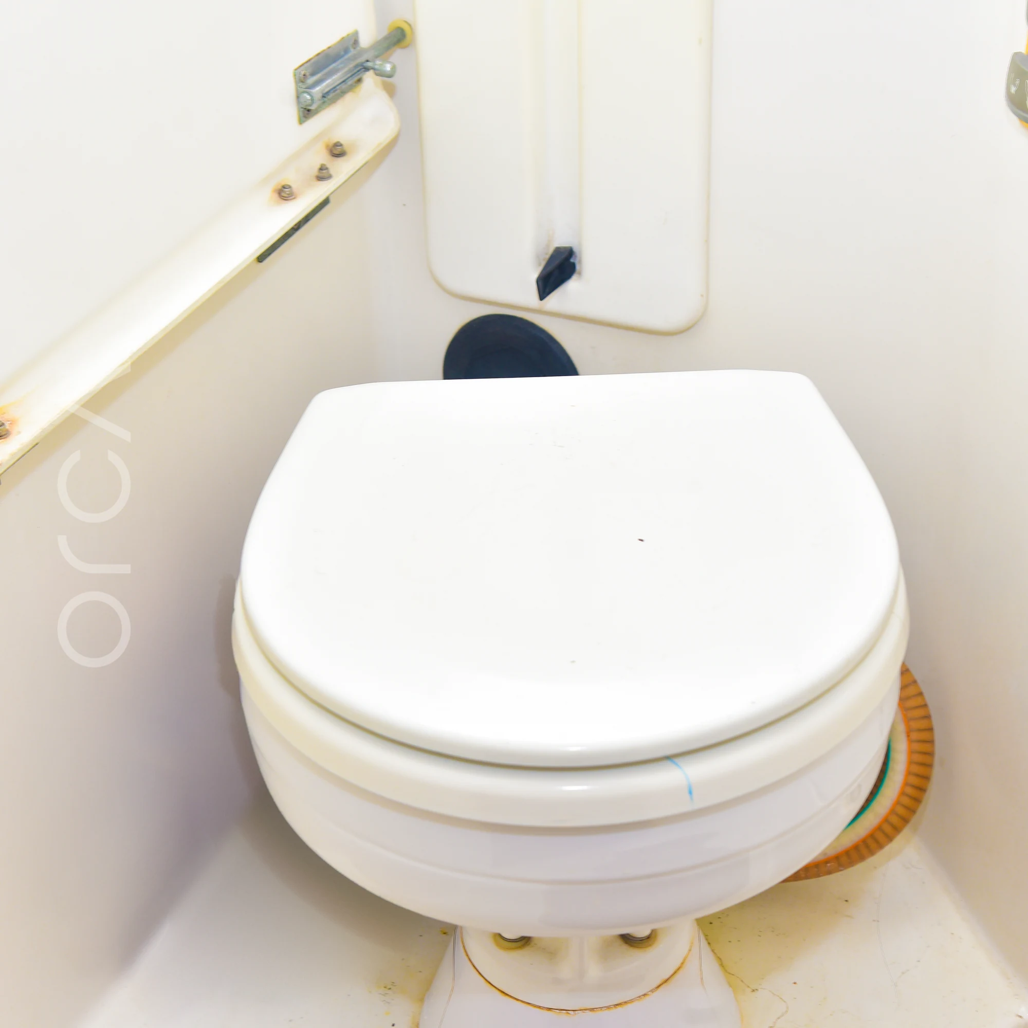 A bathroom aboard a Jeanneau 54 sail yacht in Mumbai, with a marine toilet, available to rent from Orca Sail.