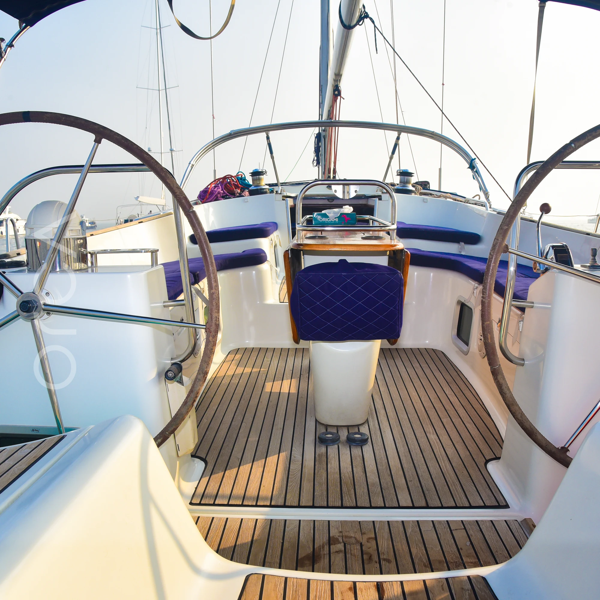 The twin wheels at the helm of a Jeanneau 54 sail yacht in Mumbai, available to rent from Orca Sail.