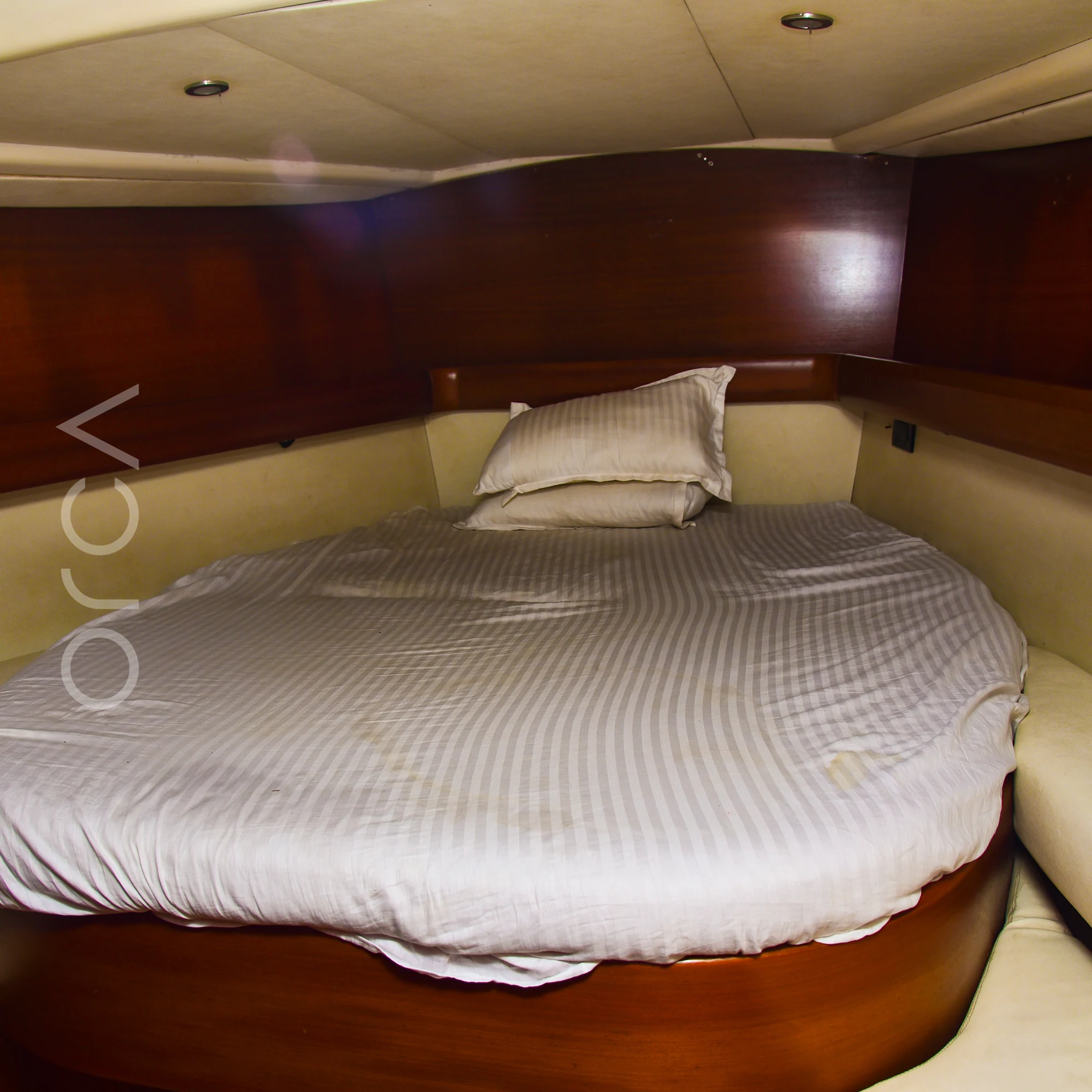 The master cabin of a Grand Soleil 45 sail yacht in Mumbai, with an island double bed, available to rent from Orca Sail.
