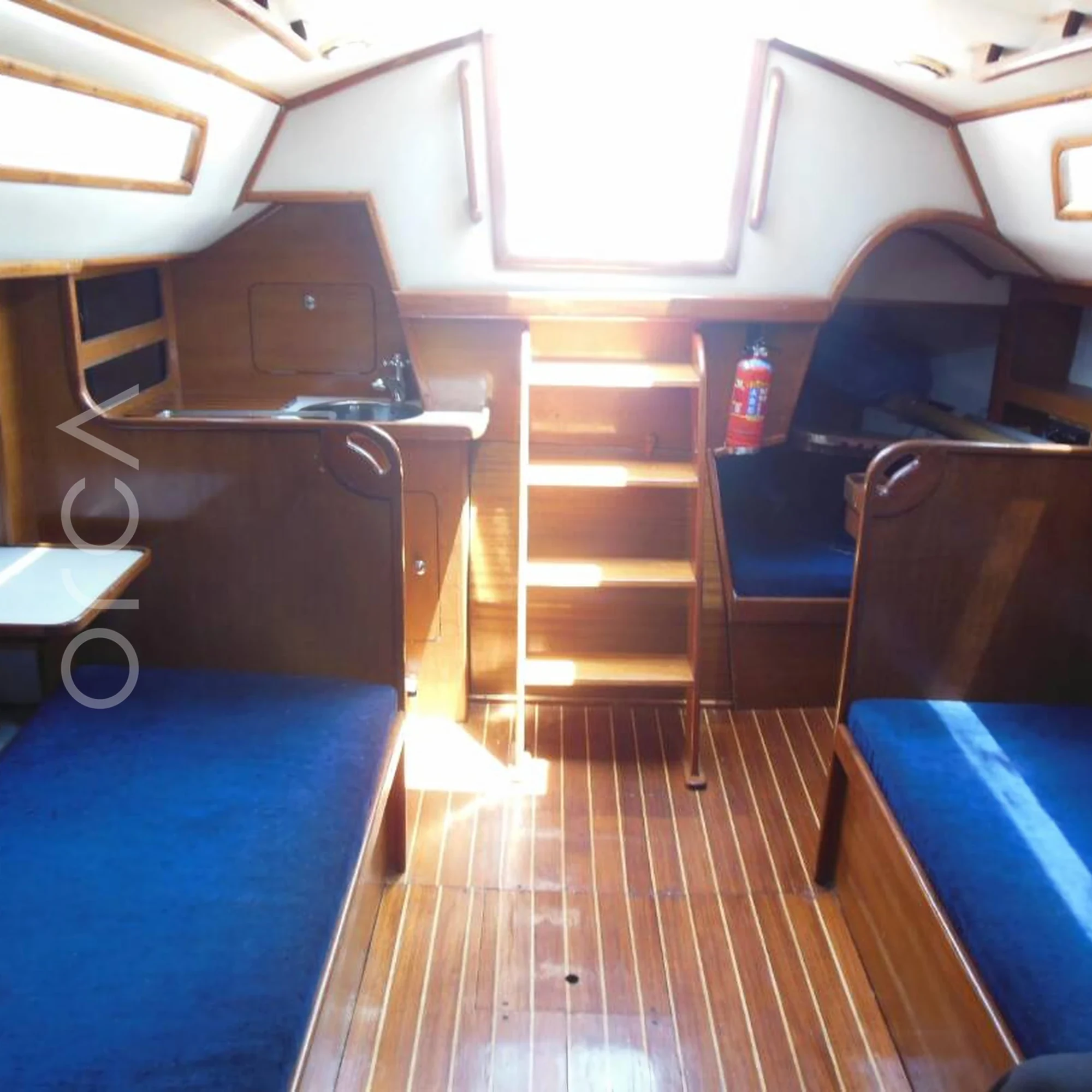 The main seating area aboard a Sigma 33 sail yacht in Mumbai, available to rent from Orca Sail.