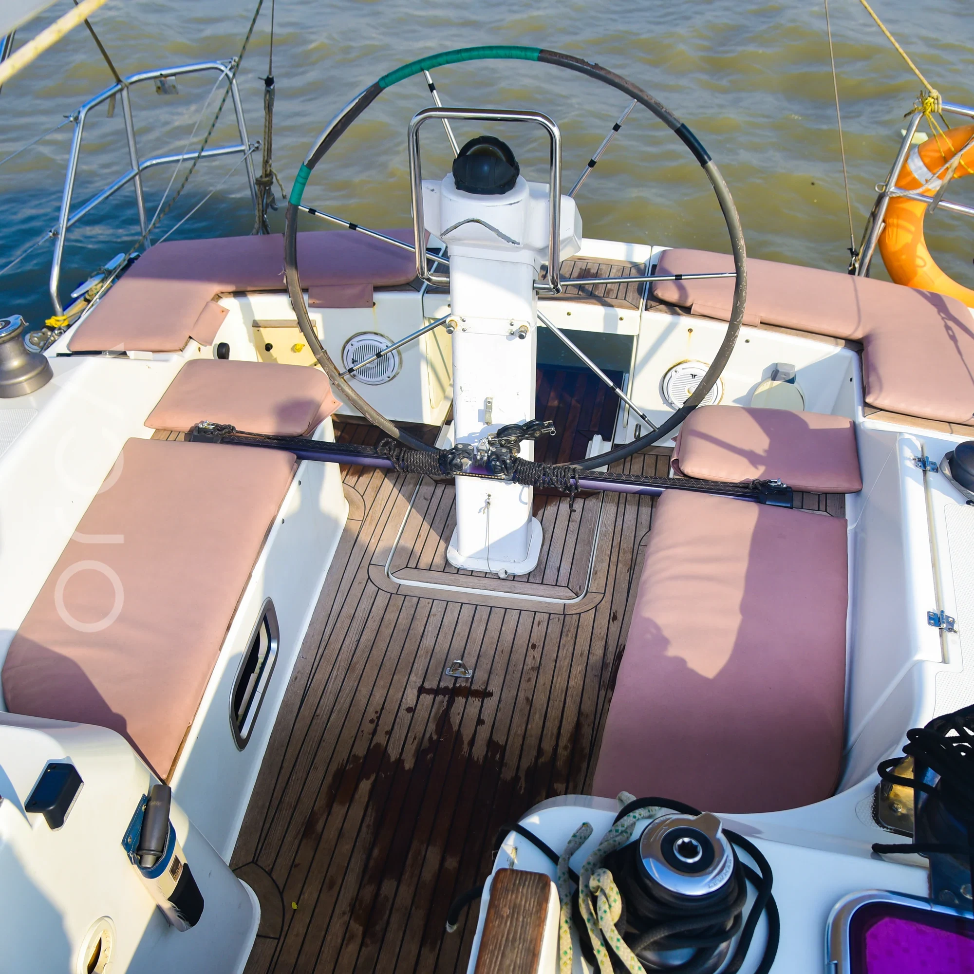 The upper deck and helm area of a Hanse 325 sail yacht in Mumbai, available to rent from Orca Sail.
