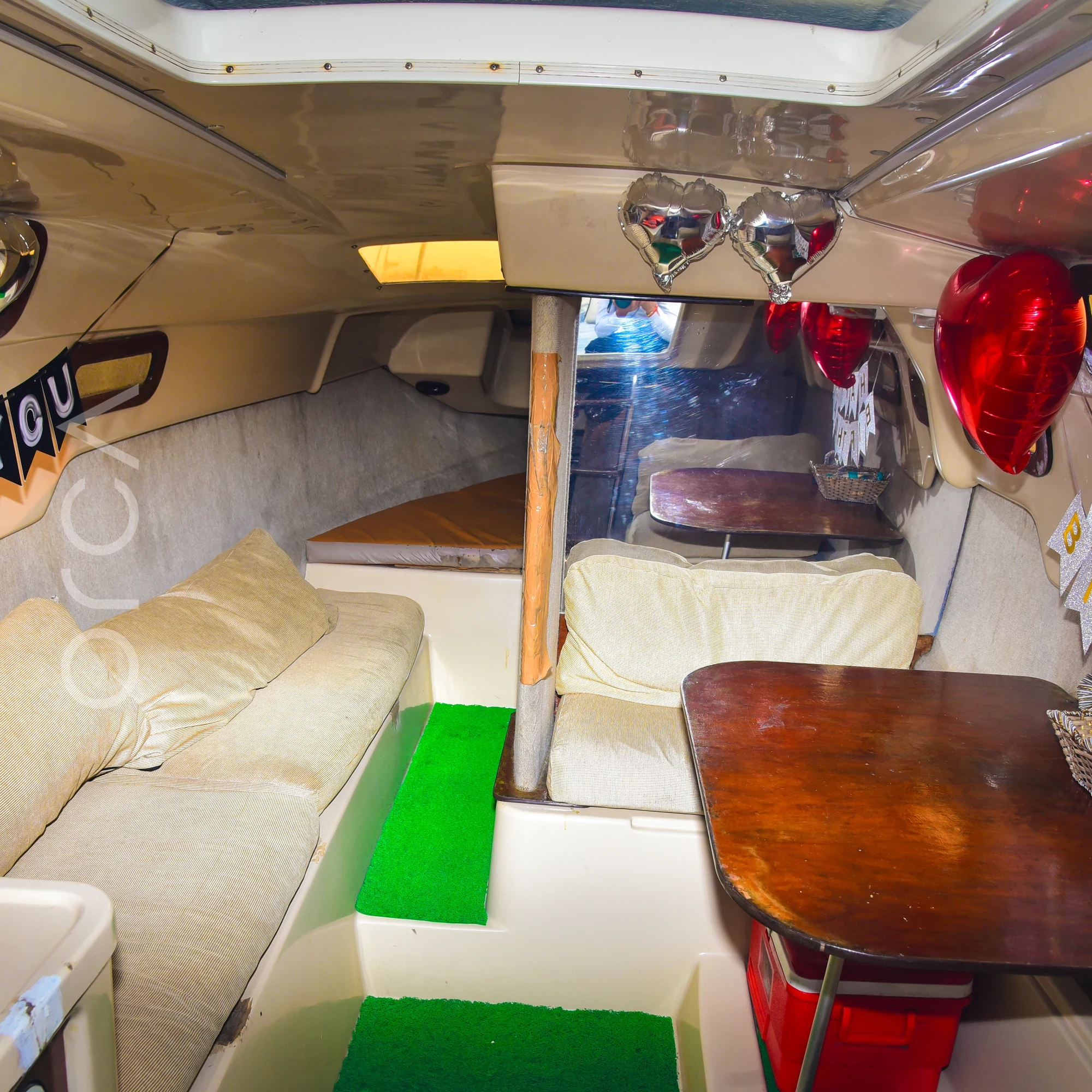 The main seating area aboard a Macgregor 26 sailboat in Mumbai, available to rent from Orca Sail.