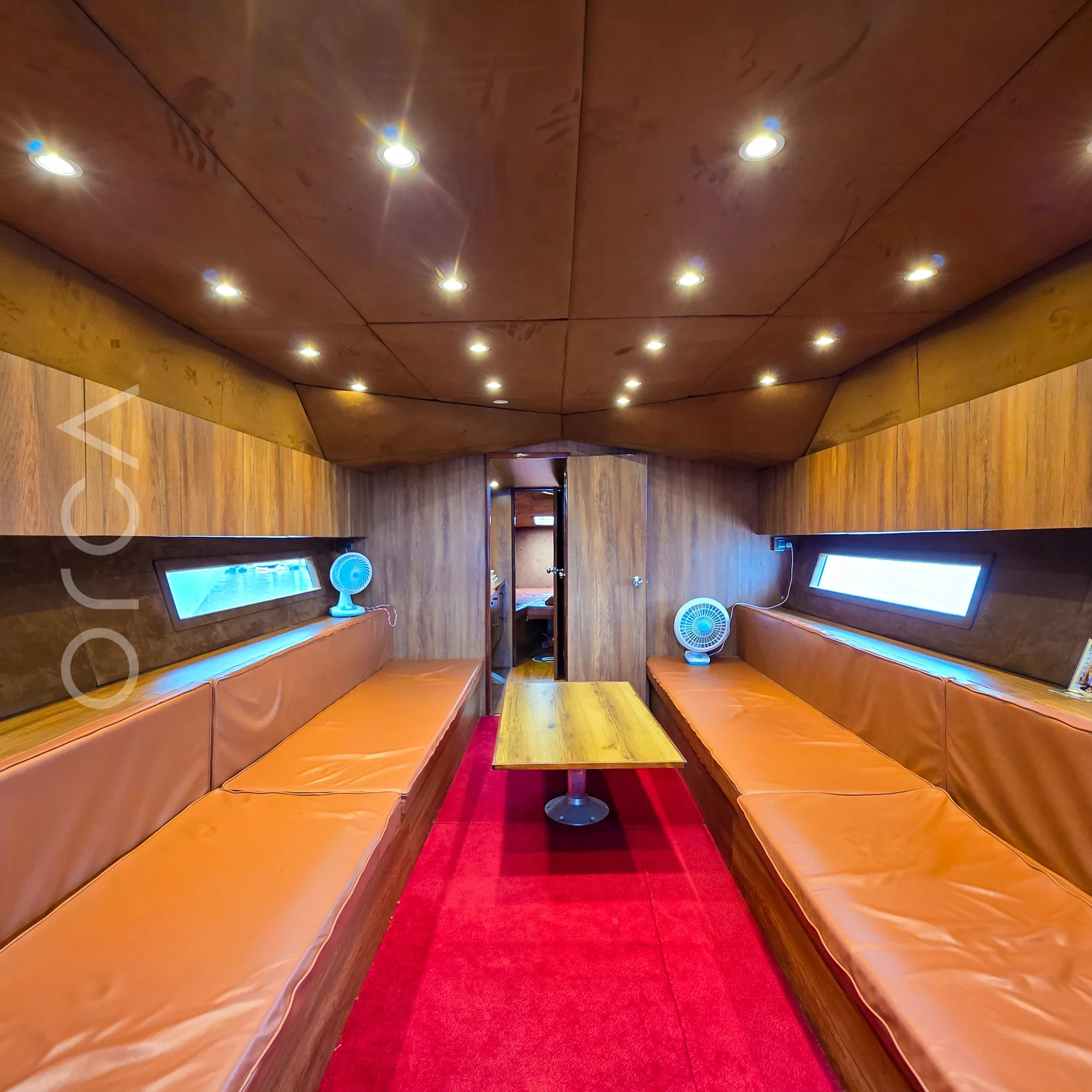 The main seating area aboard a Arc 52 cabin cruiser in Goa, available to rent from Orca Sail.