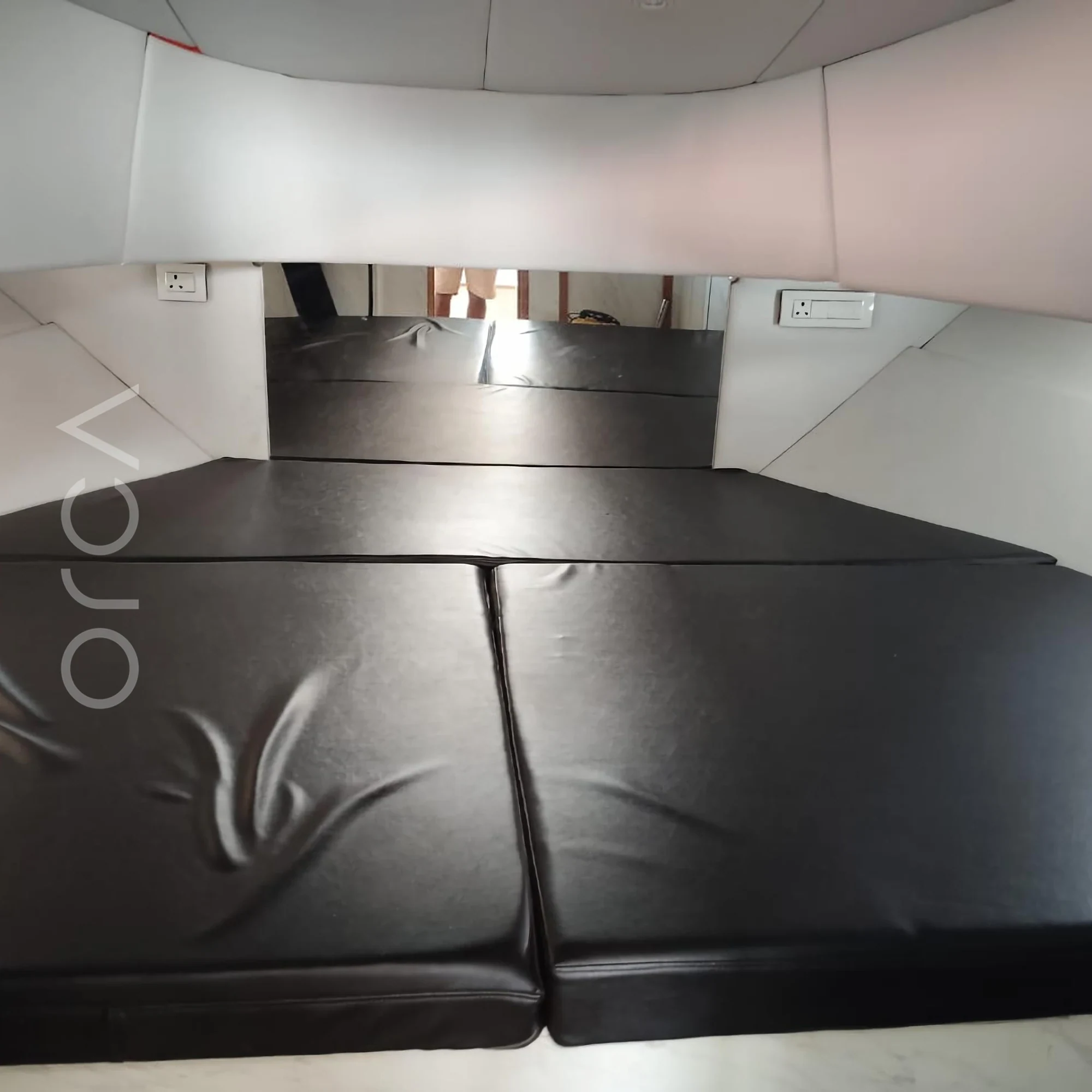 The main cabin aboard a cabin cruiser in Goa, available to rent from Orca Sail.