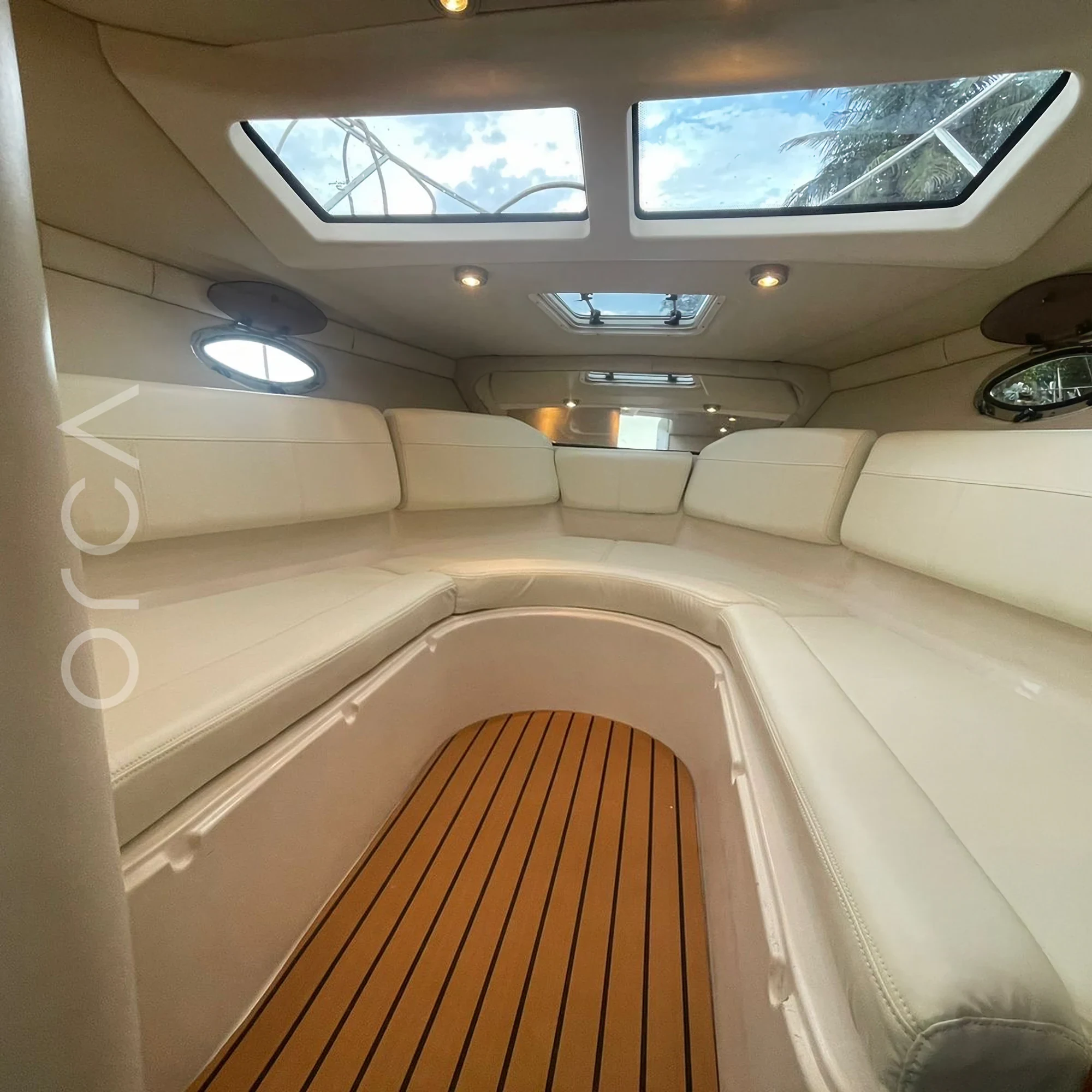 The main seating area aboard a Regal 2565 speedboat in Goa, available to rent from Orca Sail.