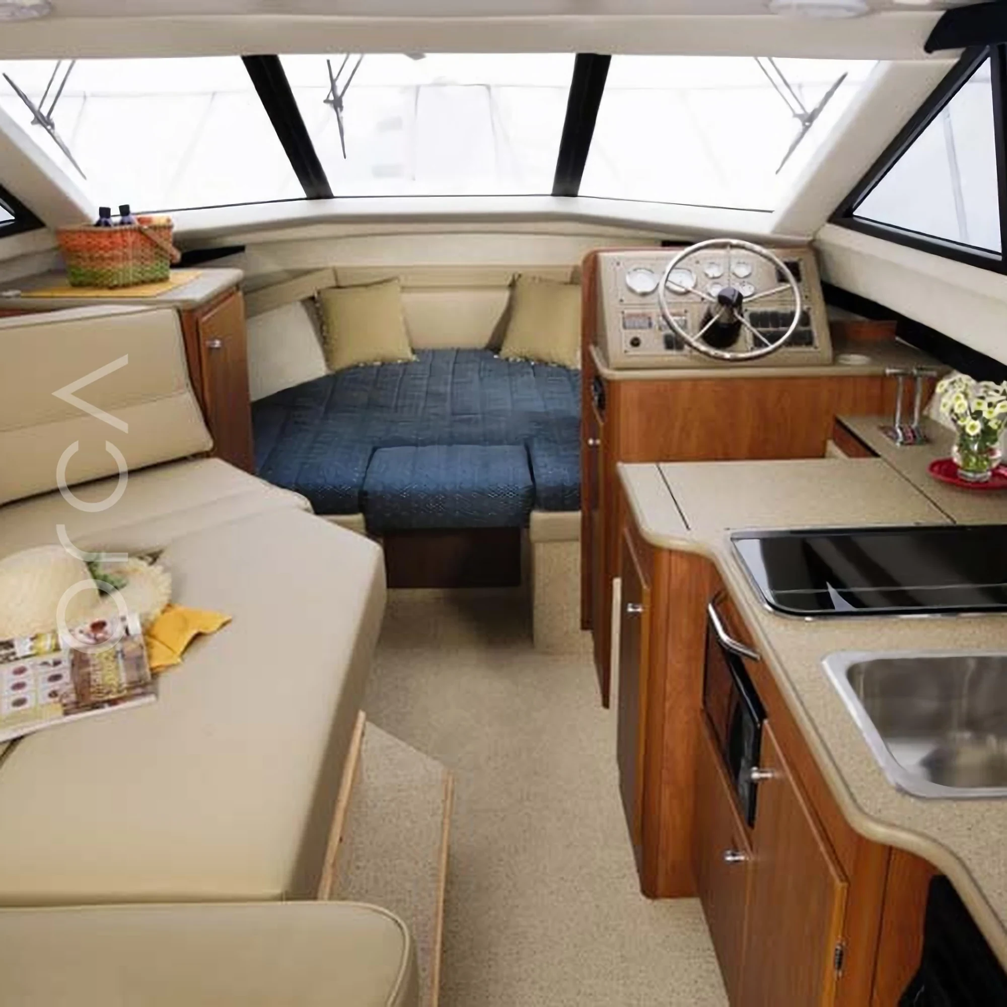 The main seating area aboard a Bayliner 340 motor yacht in Goa, available to rent from Orca Sail.