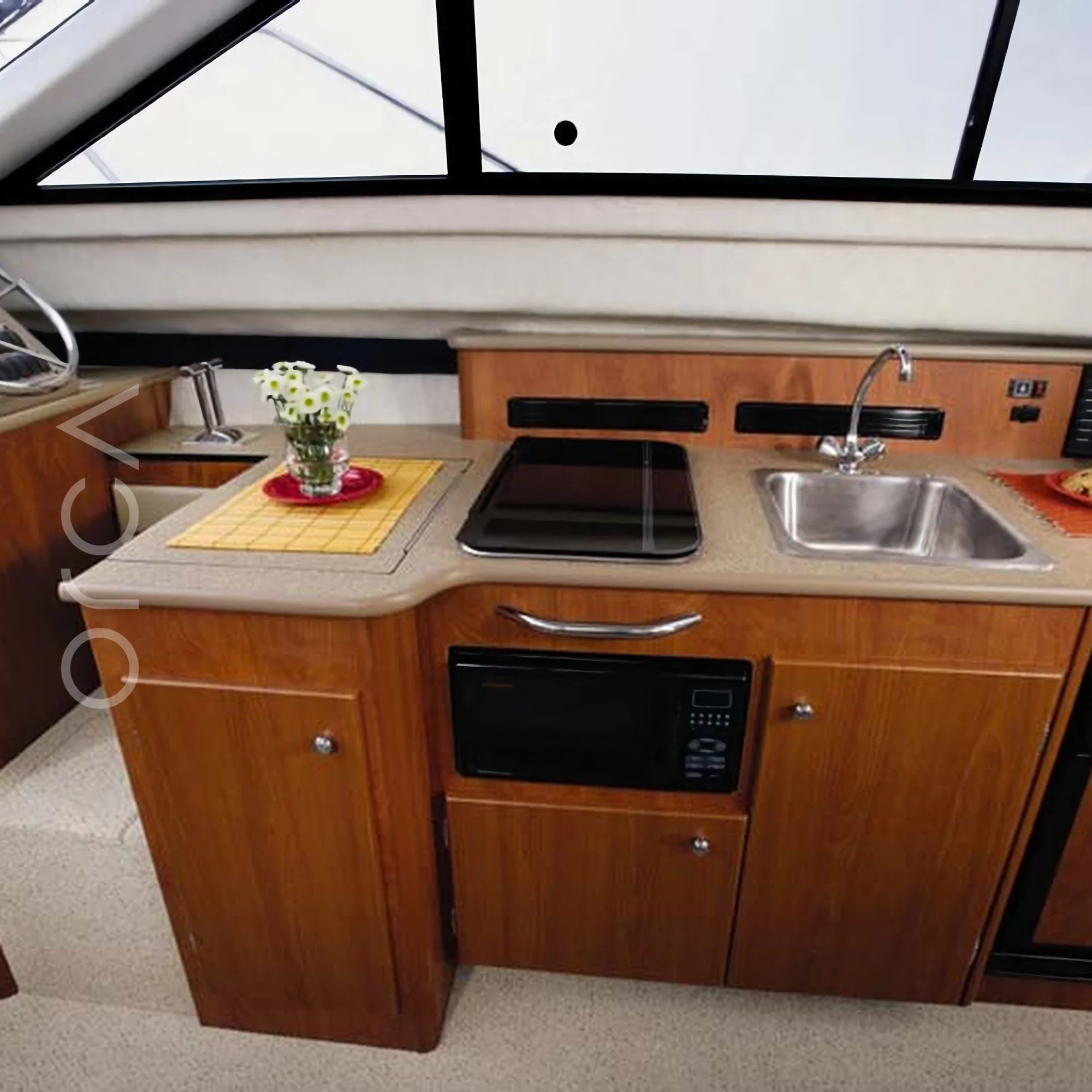 The galley aboard a Bayliner 340 motor yacht in Goa, available to rent from Orca Sail.