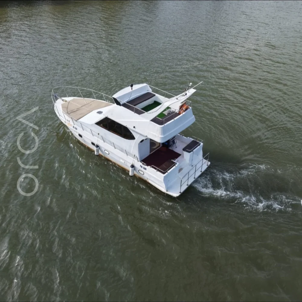 The cabin cruiser on the water in Goa, available to rent from Orca Sail.