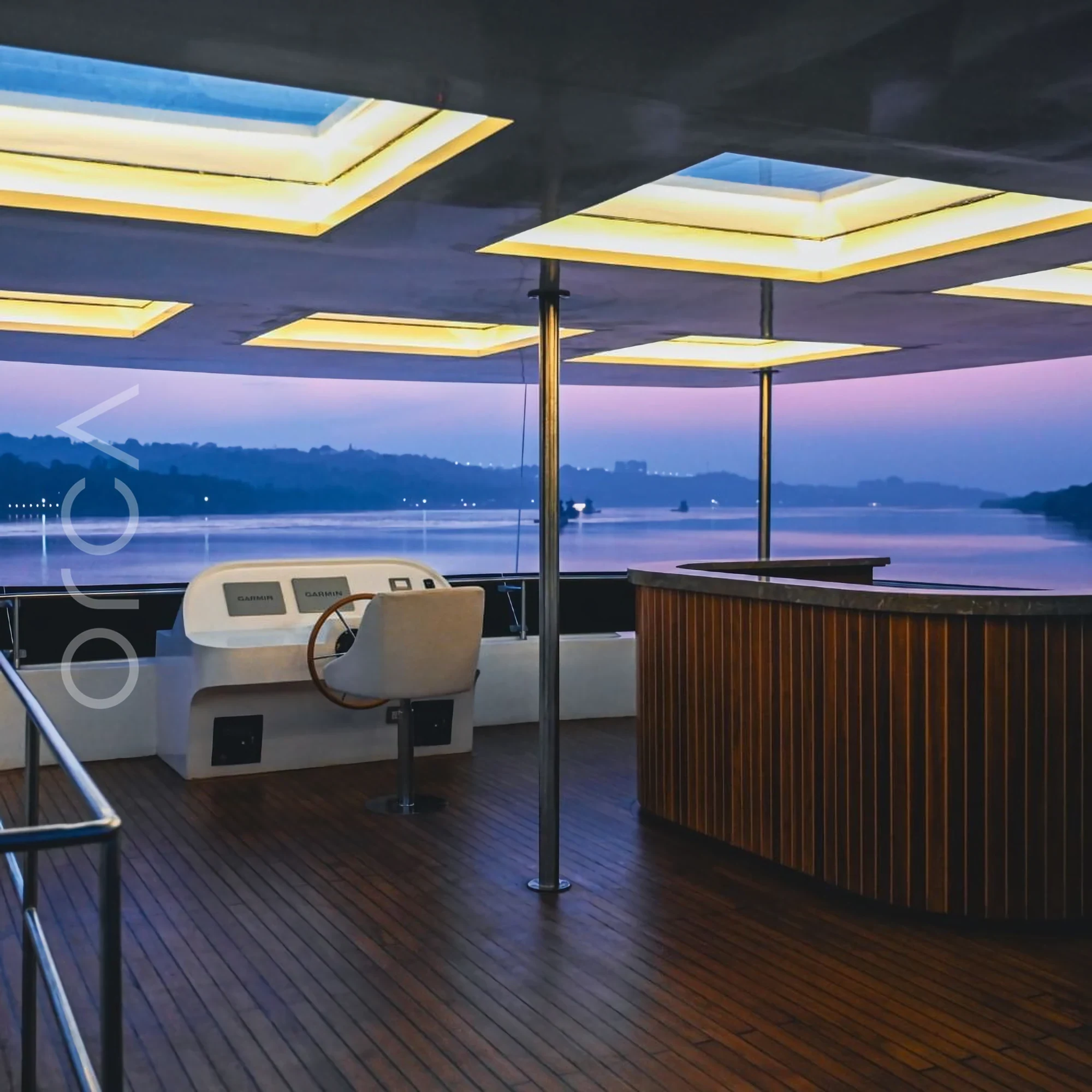 The upper deck and helm area of a cruise boat in Goa, available to rent from Orca Sail.