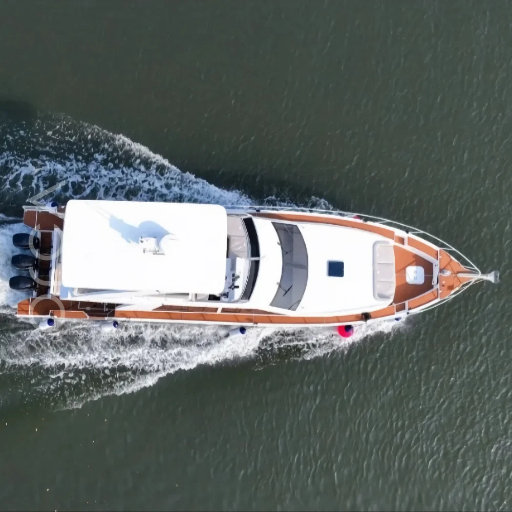 The motor yacht under way in Goa, seen from above, available to rent from Orca Sail.