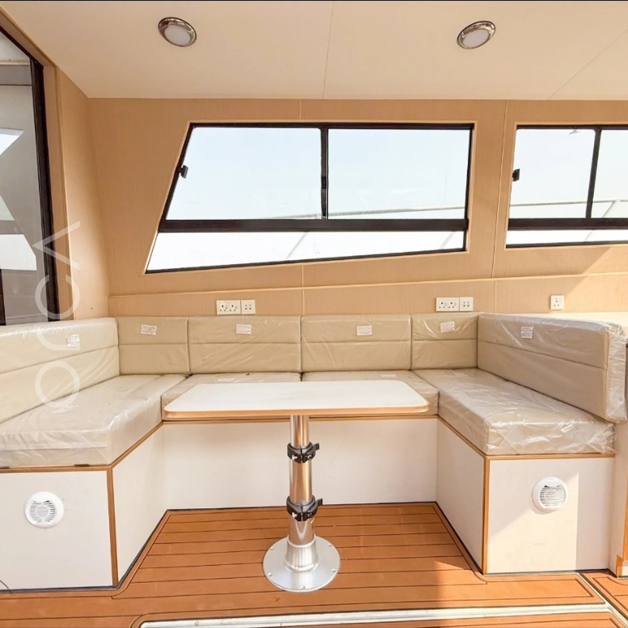 The main seating area aboard a motor yacht in Goa, available to rent from Orca Sail.