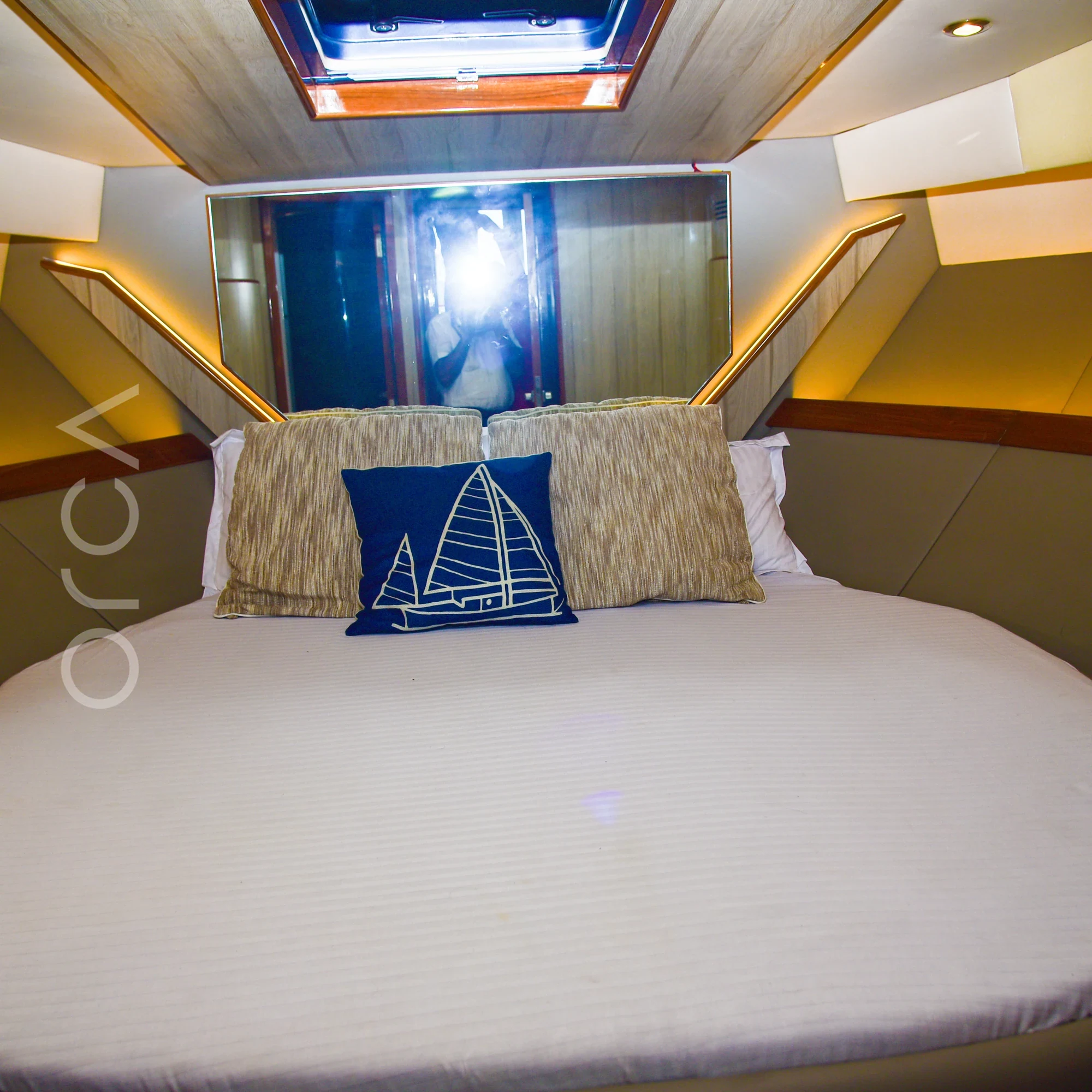 The main cabin aboard an Ambassador 47 motor yacht in Mumbai, available to rent from Orca Sail.