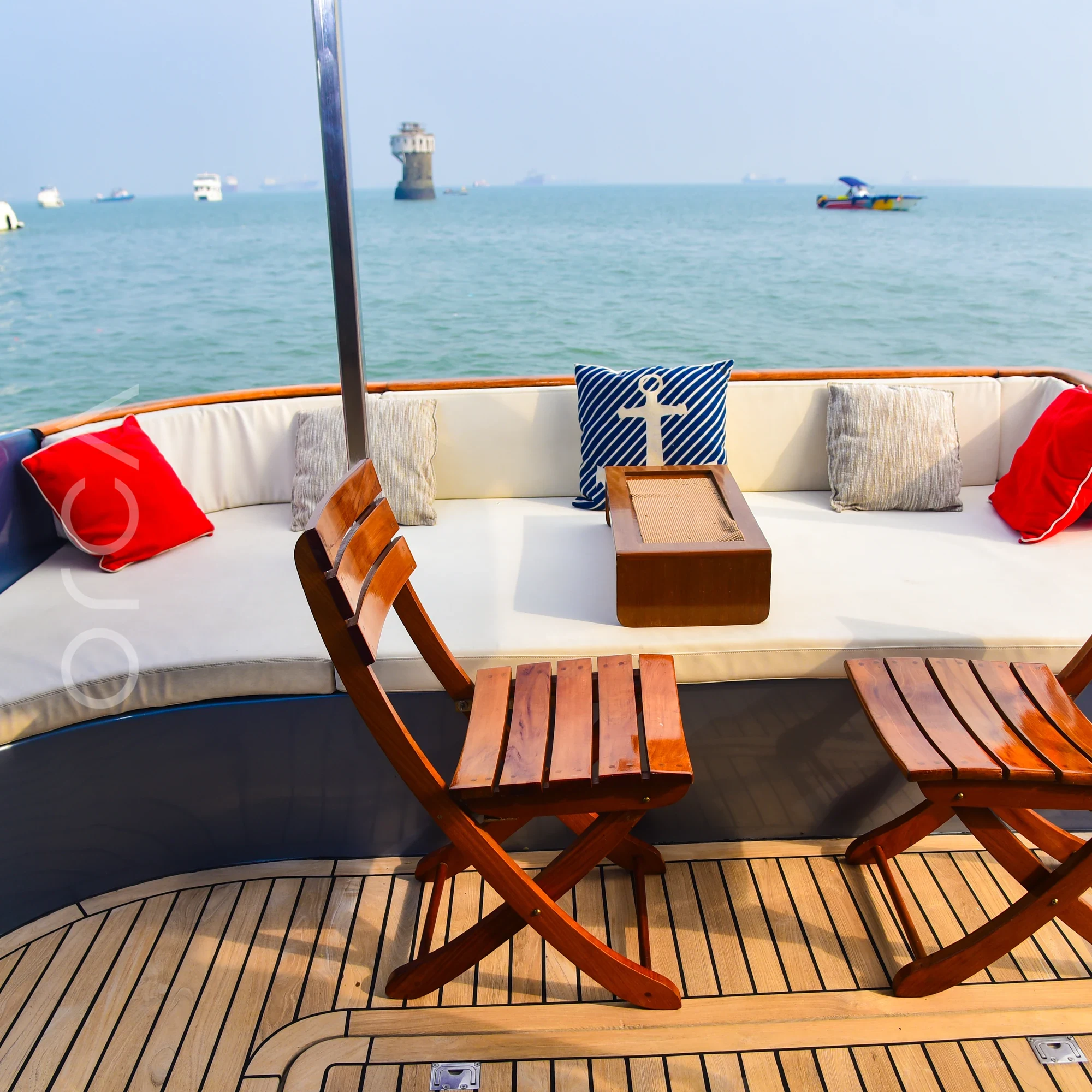 The aft deck of an Ambassador 47 motor yacht in Mumbai, available to rent from Orca Sail.