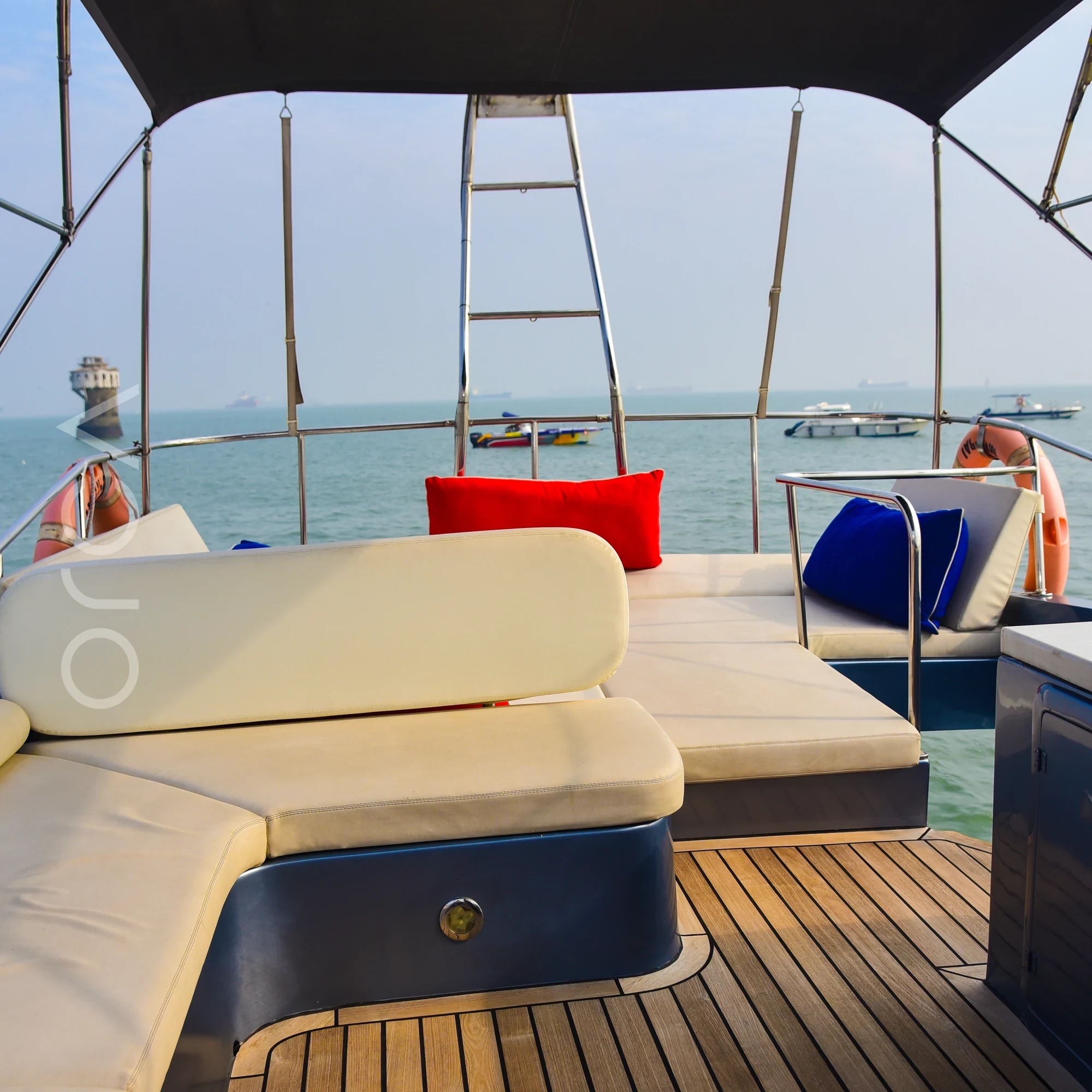 The upper deck and helm area of an Ambassador 47 motor yacht in Mumbai, available to rent from Orca Sail.