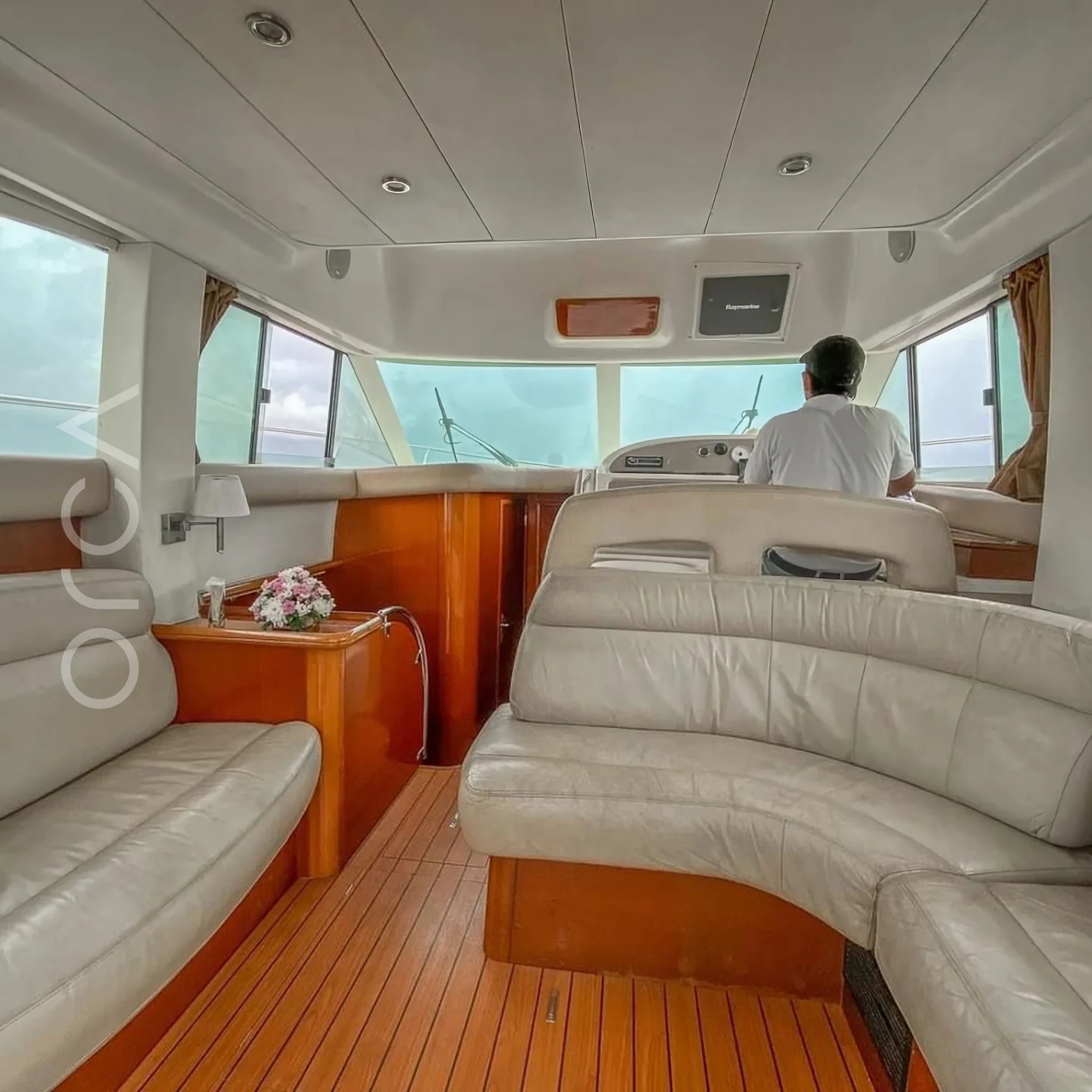 The main seating area aboard a Prestige 36 motor yacht in Goa, available to rent from Orca Sail.