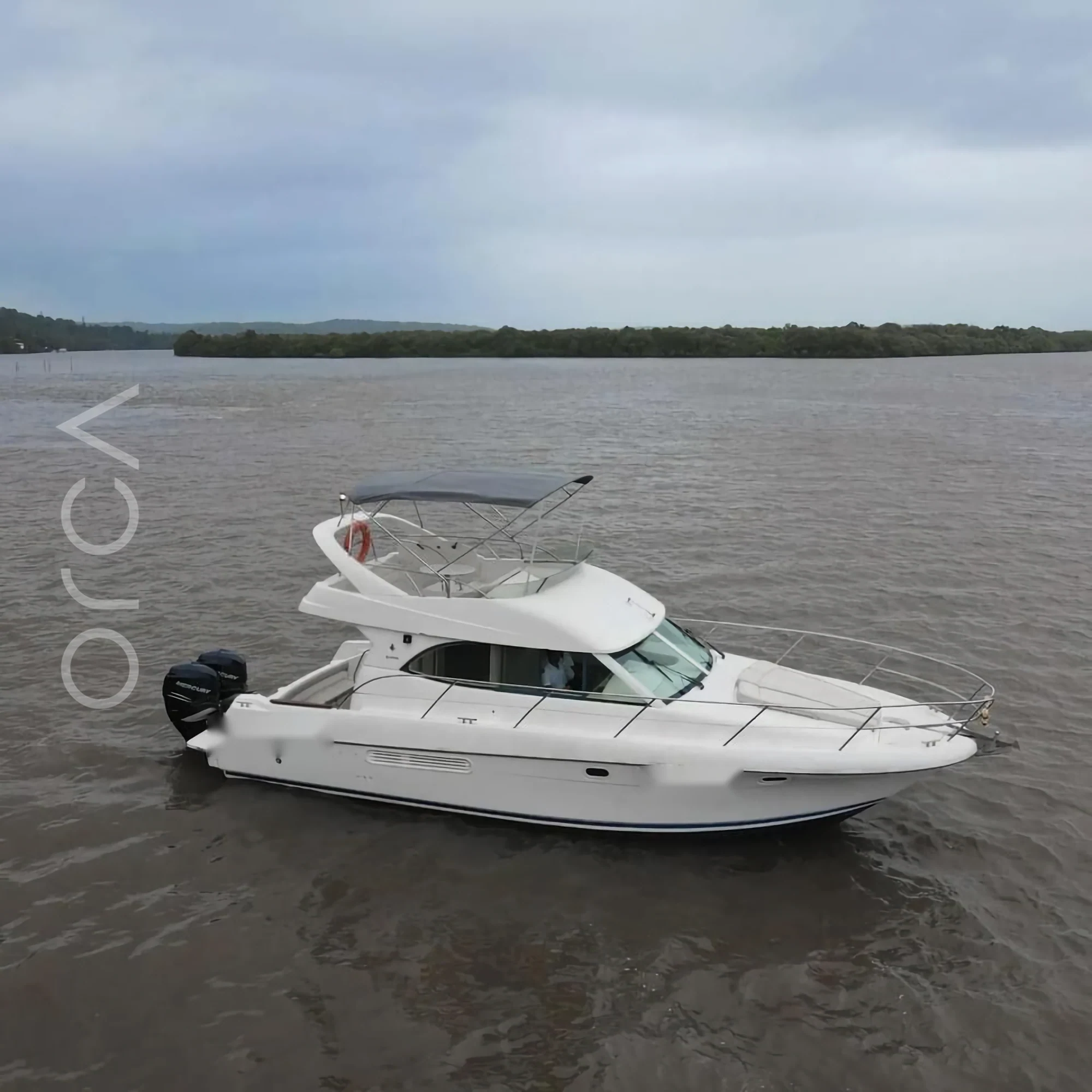 A Prestige 36 motor yacht seen side-on in Goa, available to rent from Orca Sail.
