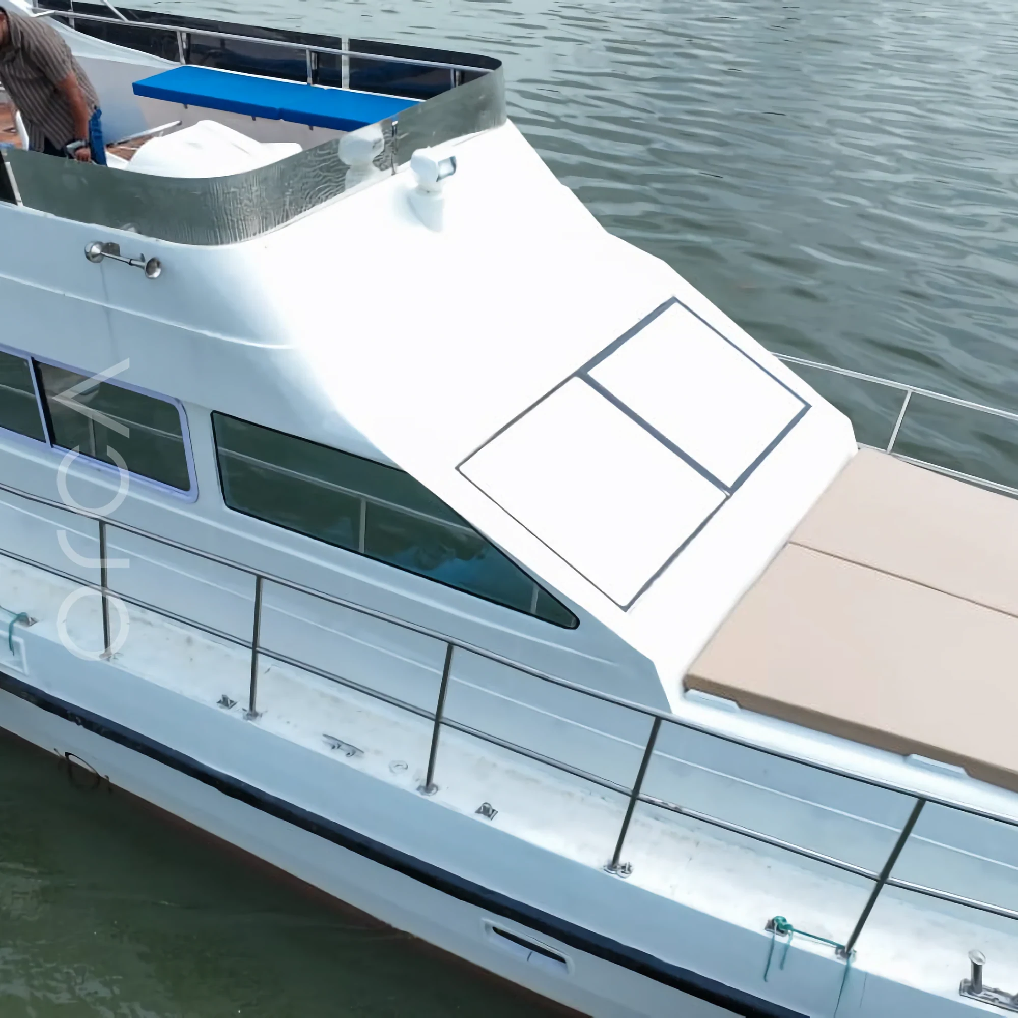 The upper deck and helm area of an Oasis motor yacht in Goa, available to rent from Orca Sail.