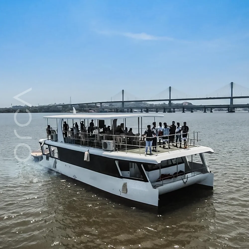 The Omsai party catamaran on the water in Goa, available to rent from Orca Sail.