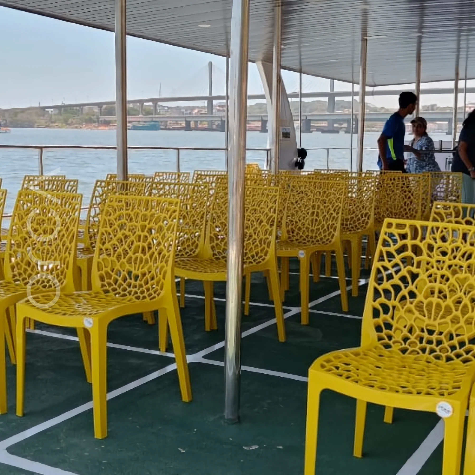 The upper deck and helm area of an Omsai party catamaran in Goa, available to rent from Orca Sail.
